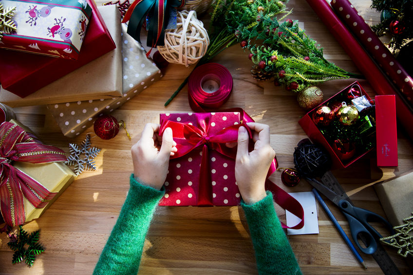 overhead shot of christmas presents and wrapping papers